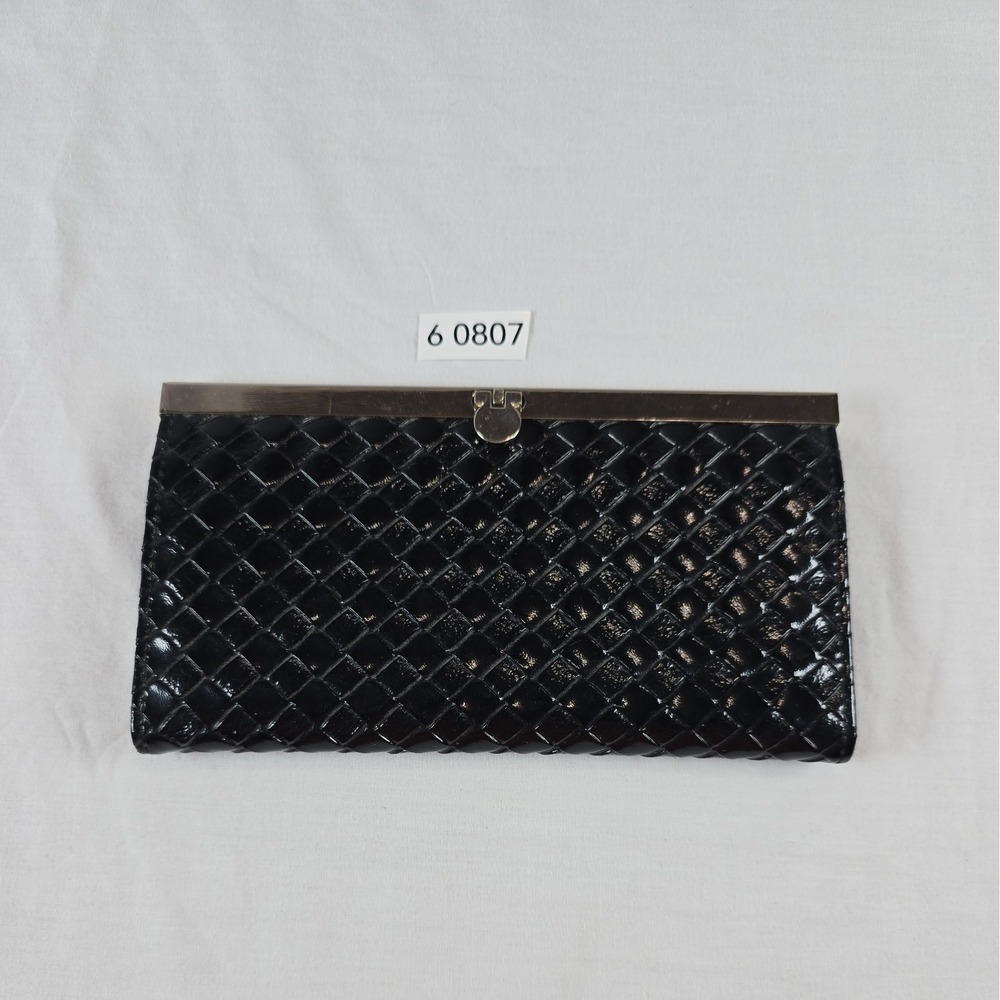 Elegant Black Clutch With Silver Accents And Unique Clasp